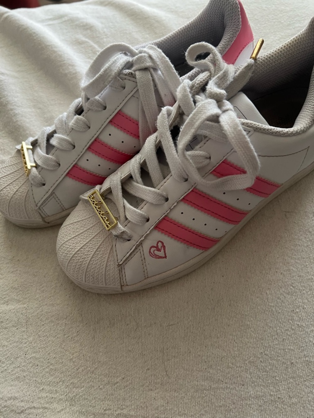 adidas White and Pink Kids Shell-Toe Sneakers with Heart Detail.